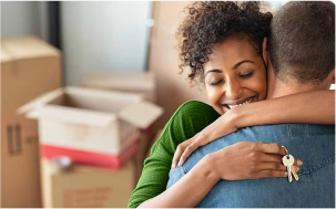 Couple hug after buying a home